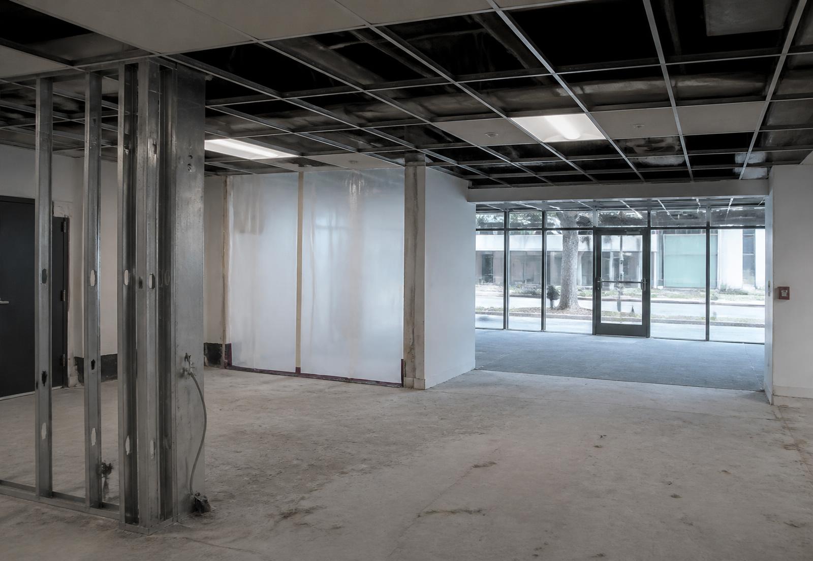Commercial interior during selective demolition with exposed ceiling grid